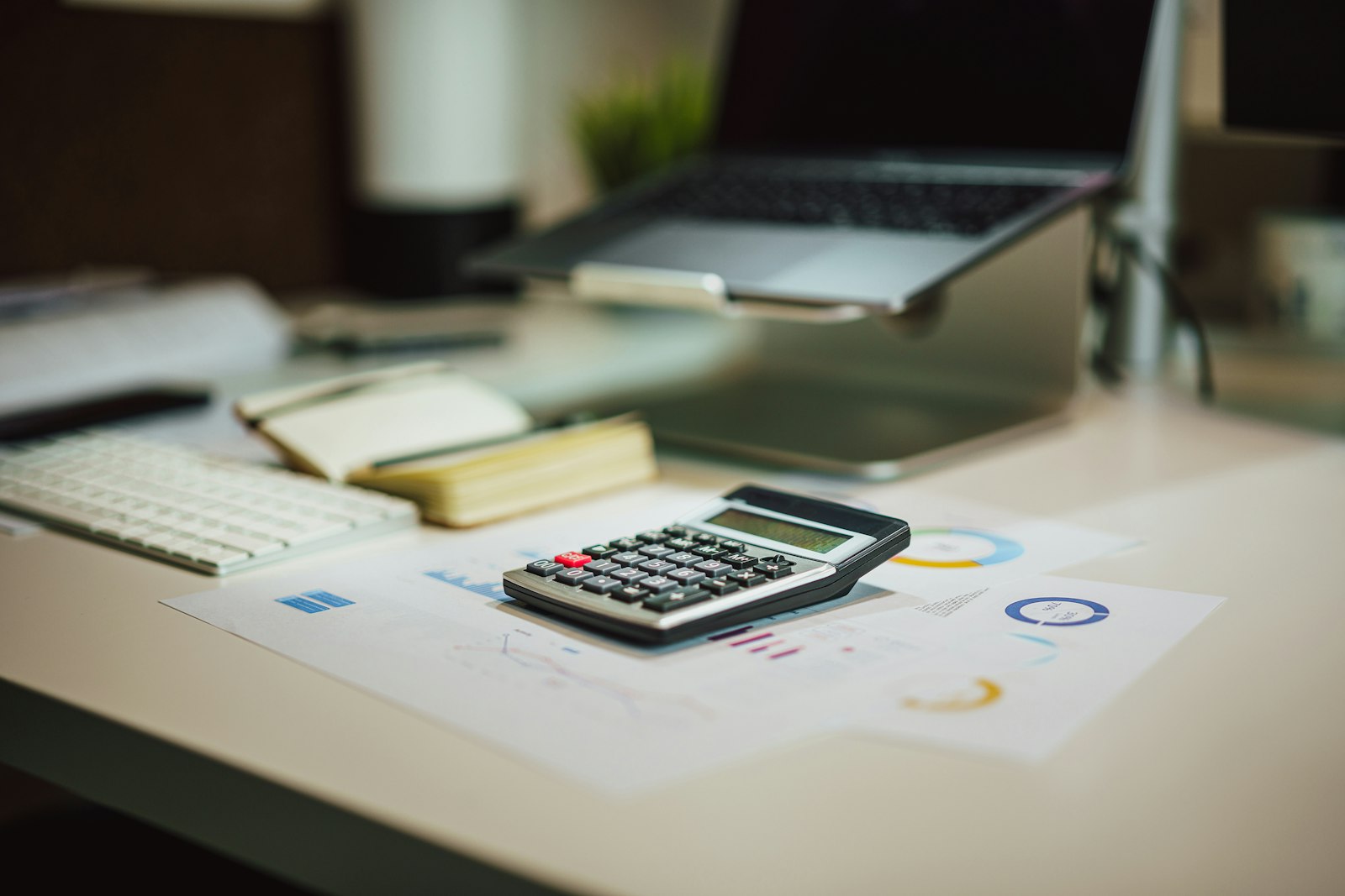 Calculator and laptop used to work out the tax treatment of a remote work stipend