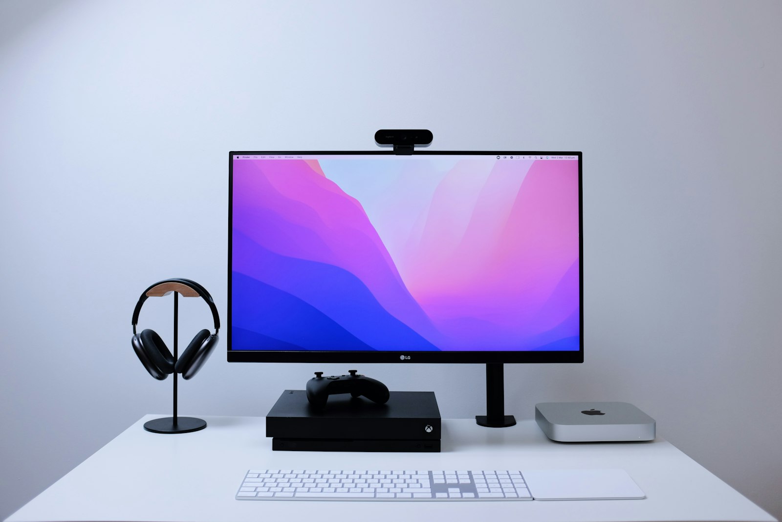Single computer monitor mounted on an arm above a clean desk